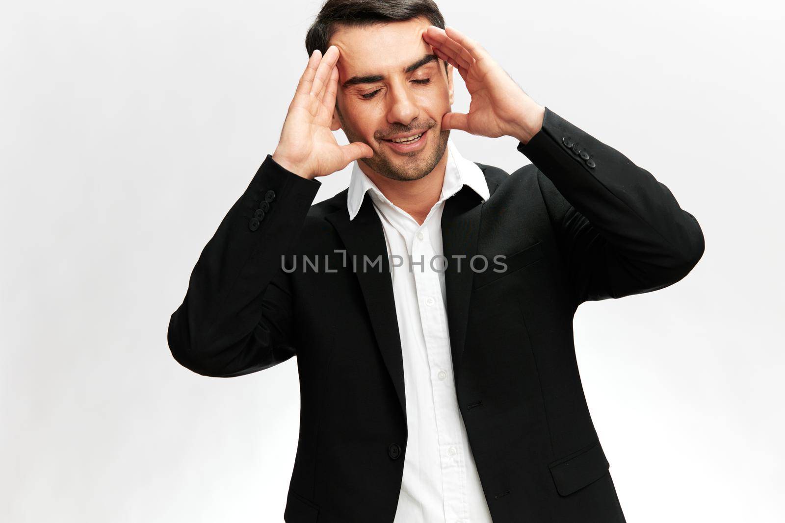 handsome man in a stylish suit smile posing self-confidence light background. High quality photo