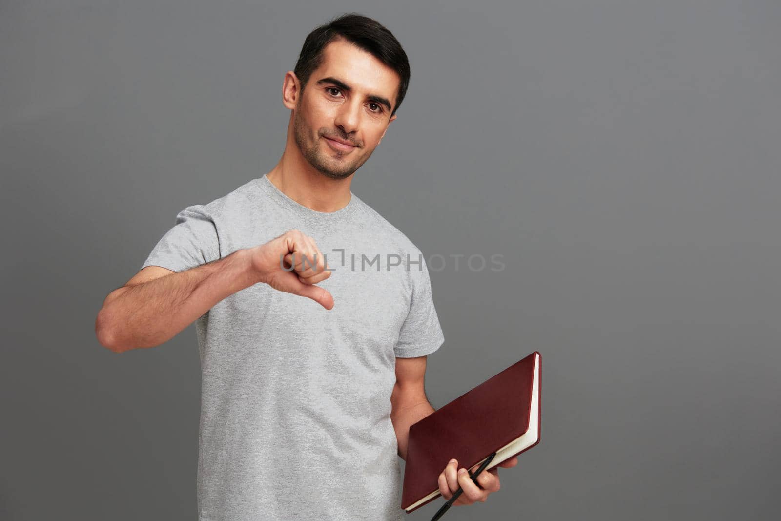 Cheerful man in gray t-shirts posing lifestyle casual wear cropped view by SHOTPRIME