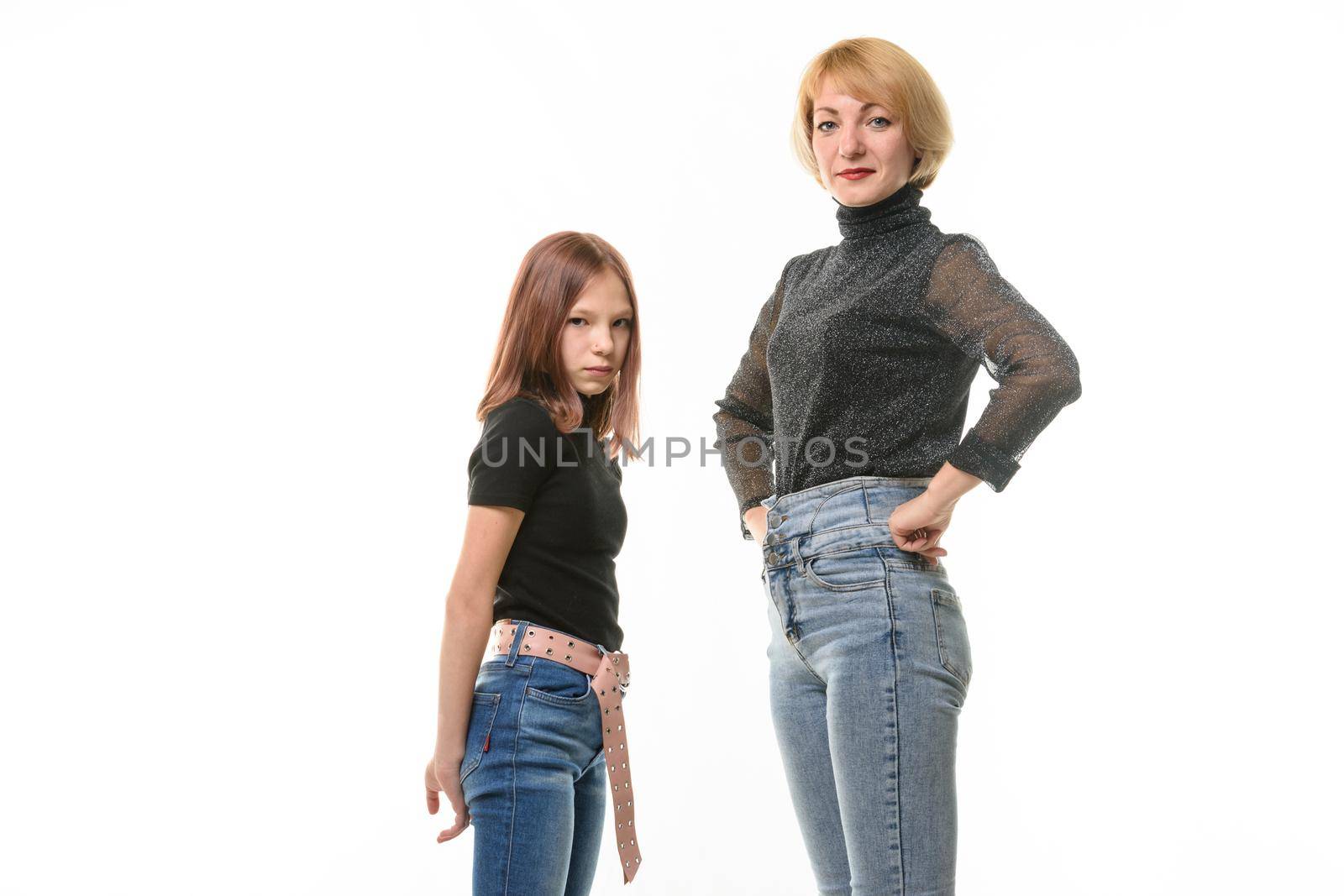 Upset girl and smiling girl look into the frame, isolated on white background a