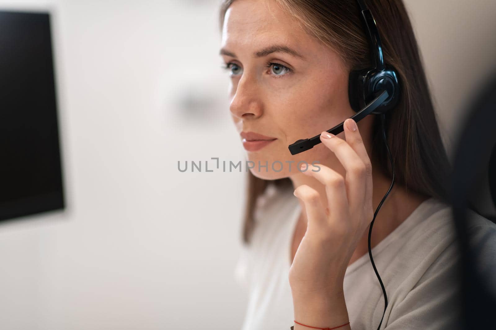 Helpline female operator with headphones in call centre.Business woman with headsets working in a call center. Selective focus by dotshock