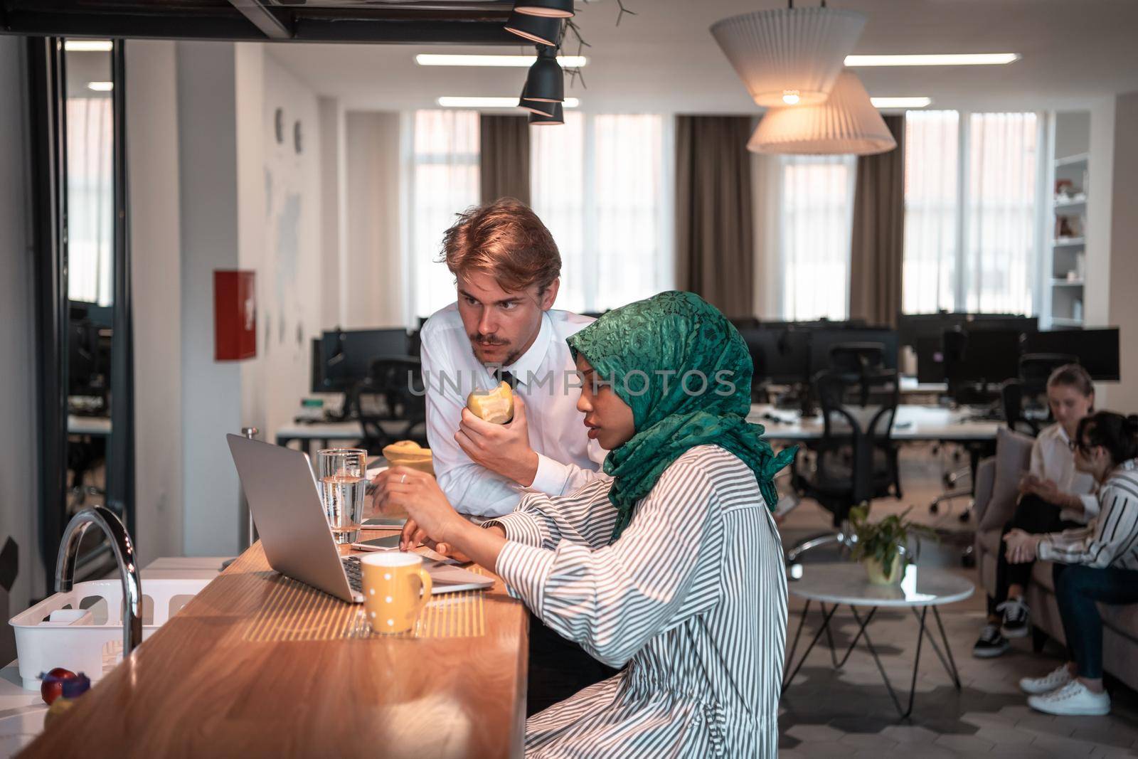International multicultural business team. A young businessman and businesswoman sit in a modern relaxation space and talk about a new business. High-quality photo