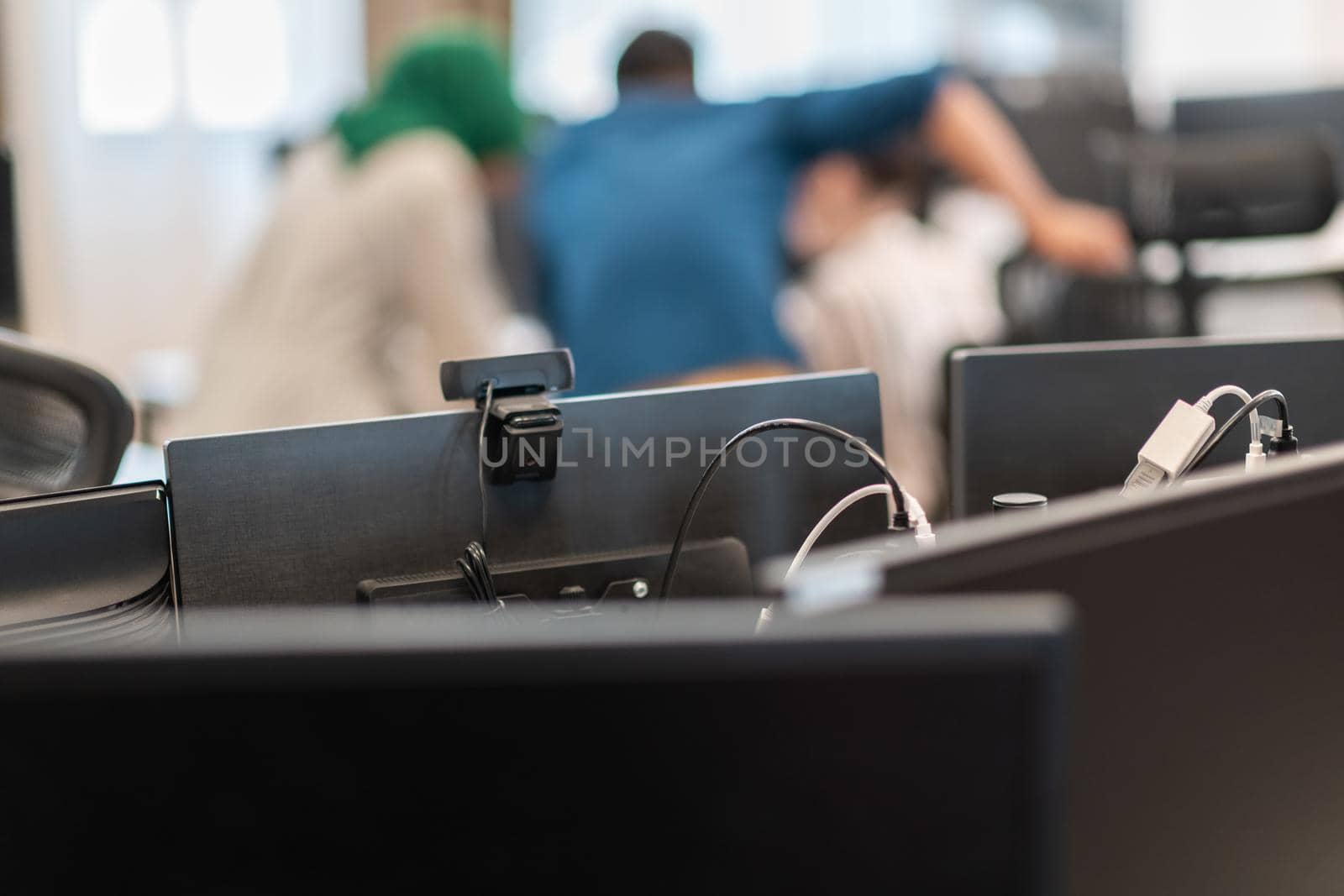 Multiethnic startup business team Arabian woman wearing a hijab on meeting in modern open plan office interior brainstorming, working on laptop and desktop computer. Selective focus by dotshock