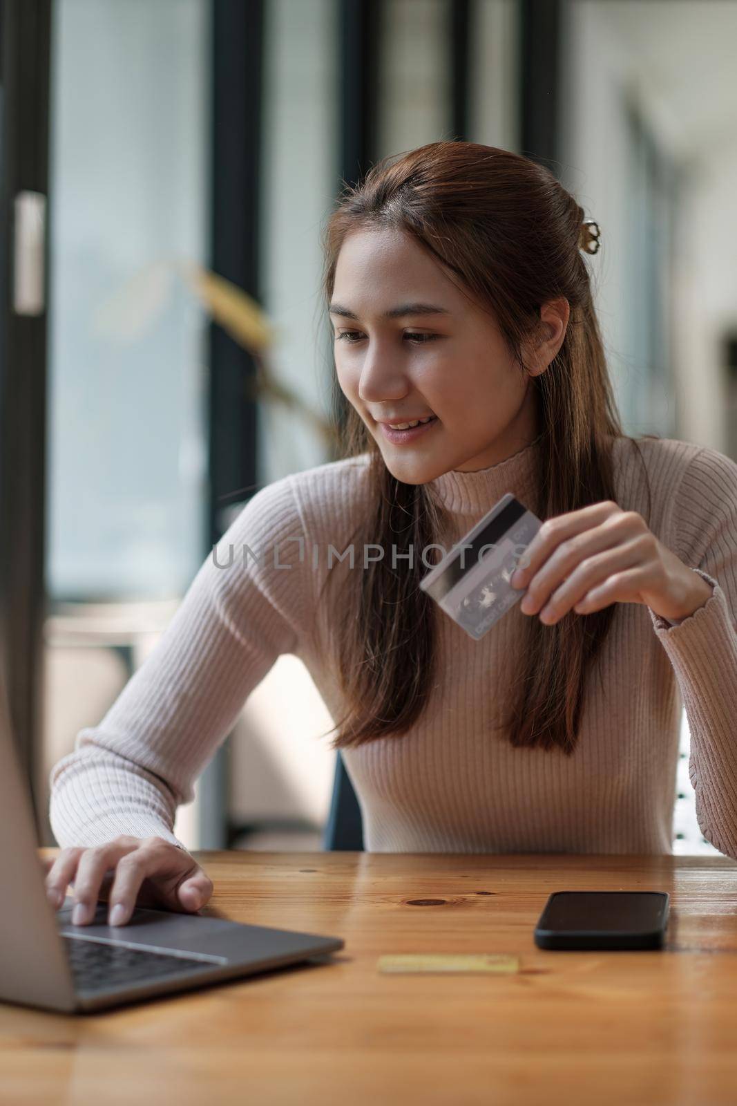 Portrait smiling asian woman resting and shopping online at home, Happy woman using laptop and credit card for online shopping. Online payment concept