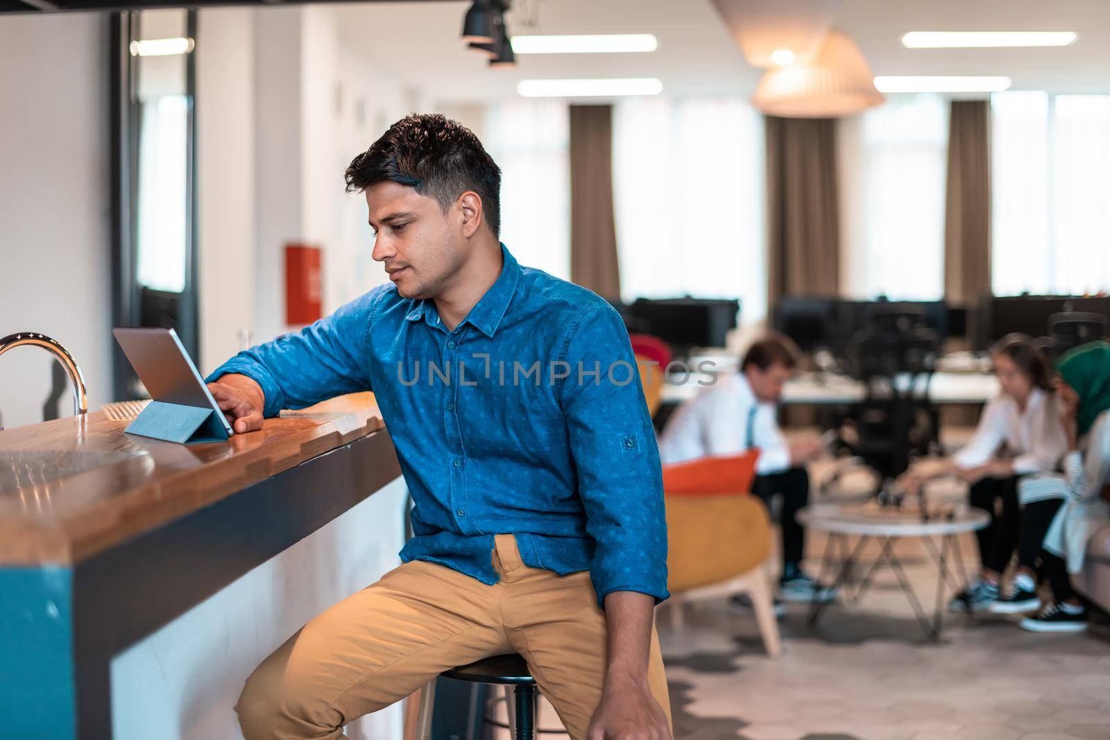 Casual businessman with headphones around his using laptop for an online meeting. Selective focus. High-quality photo