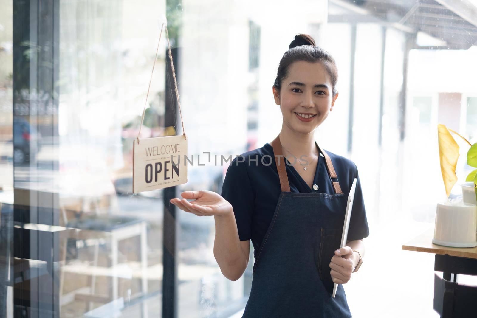 Portrait of asian woman barista cafe owner smile while cafe open. SME entrepreneur seller business concept. by itchaznong