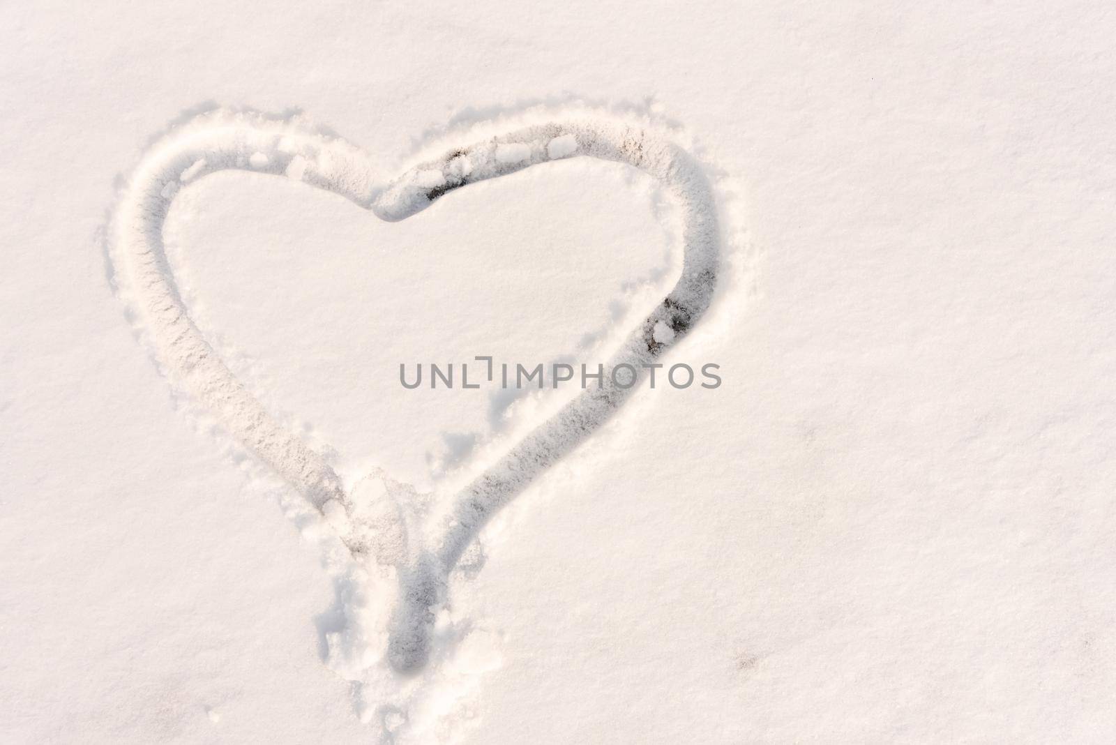 The symbol of the heart, painted on the fresh white snow with copy space by karpovkottt