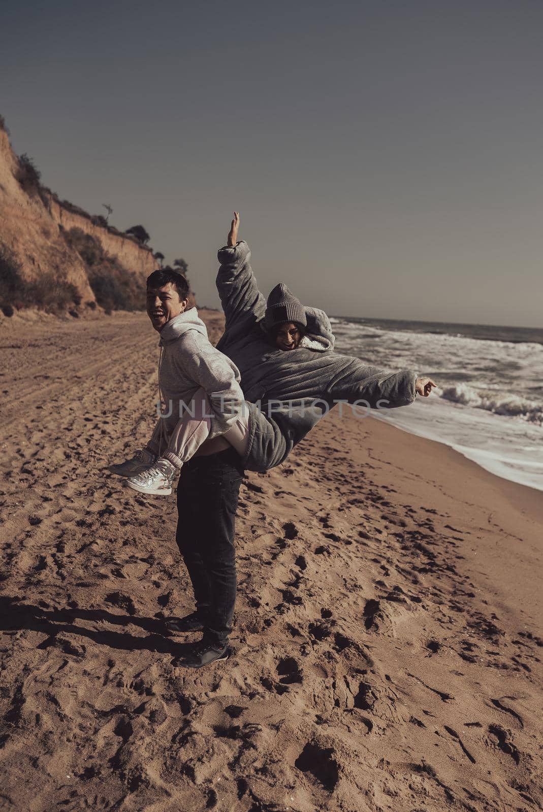 A man and a woman enjoy each other on the seashore. Have fun together