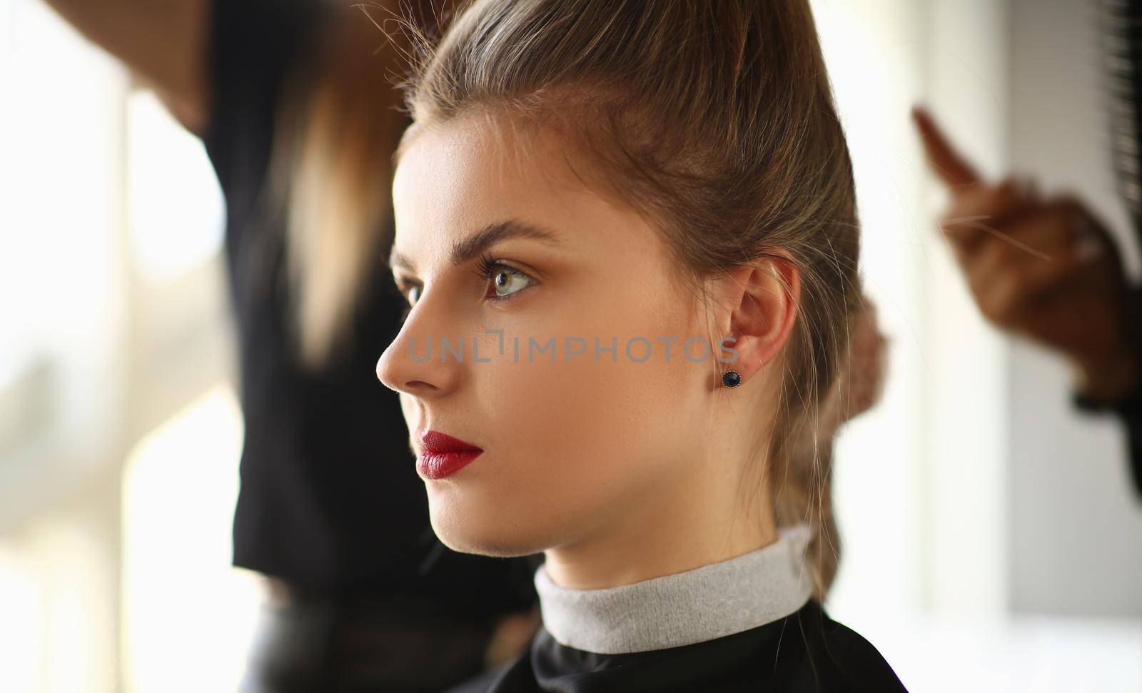 Portrait of a young woman at hairdresser. Beauty salon services and trendy haircuts concept