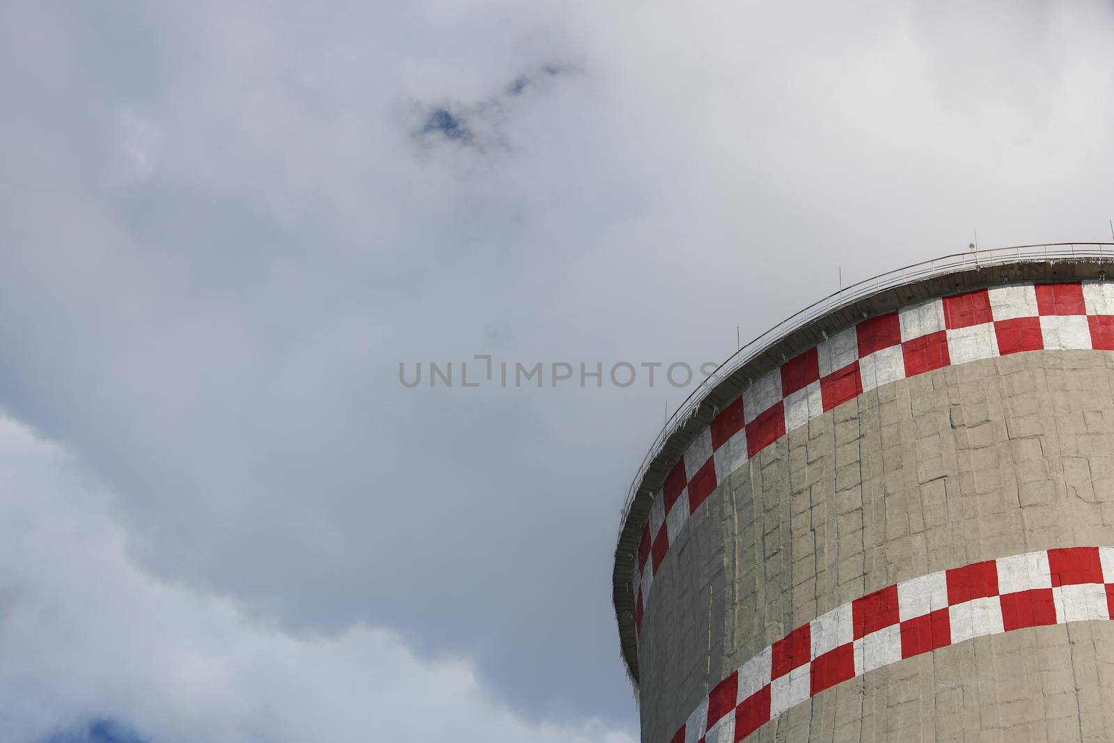 Coal-fired power plant tower blowing white smoke into sky. by kuprevich