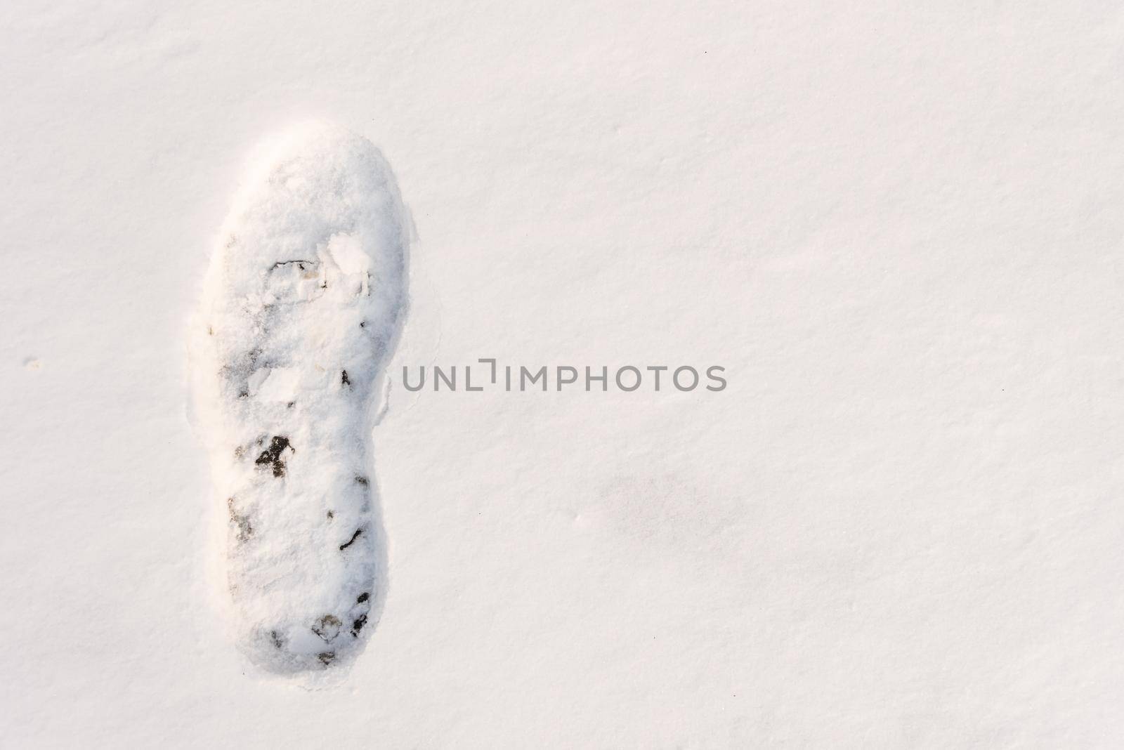 footprints on the snow under sunlight close-up with copy space.