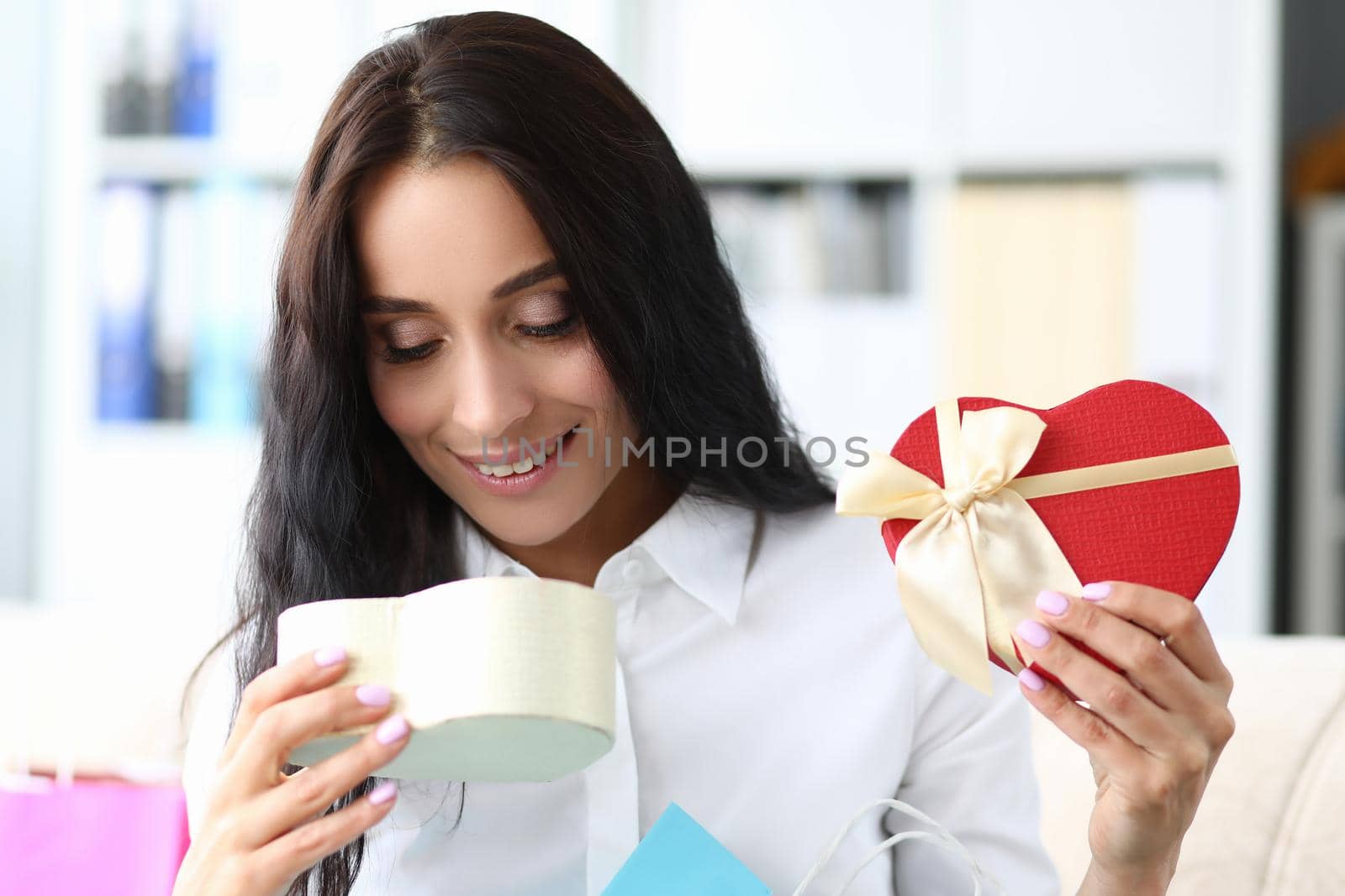Young smiling woman opens gift box closeup by kuprevich