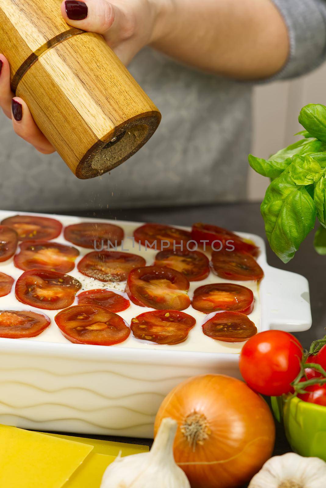 Woman preparing meat lasagna in kitchen. Italian food. lasagna recipe