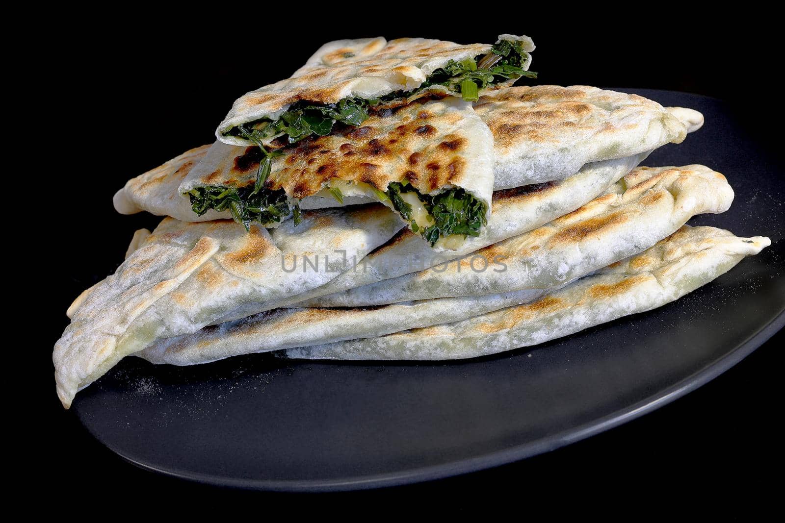 Baking of traditional Armenian food - Zhengyal bread. Bread with different greens. Cross-section of an Armenian Zhengyal bread with shallow depth of field by Proxima13