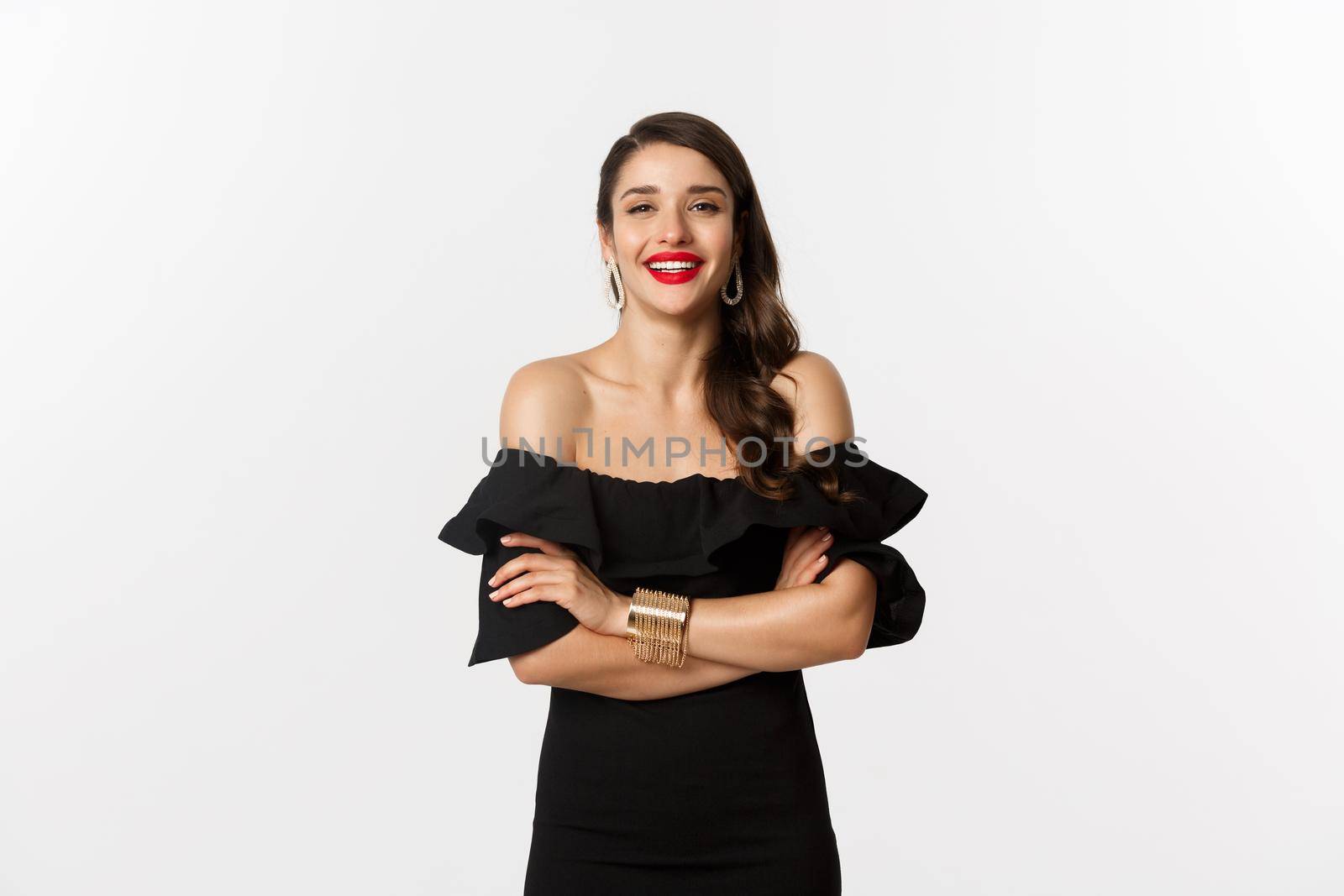 Beauty and fashion concept. Attractive female model in party dress and red lipstick, smiling pleased, looking happy, standing over white background by Benzoix