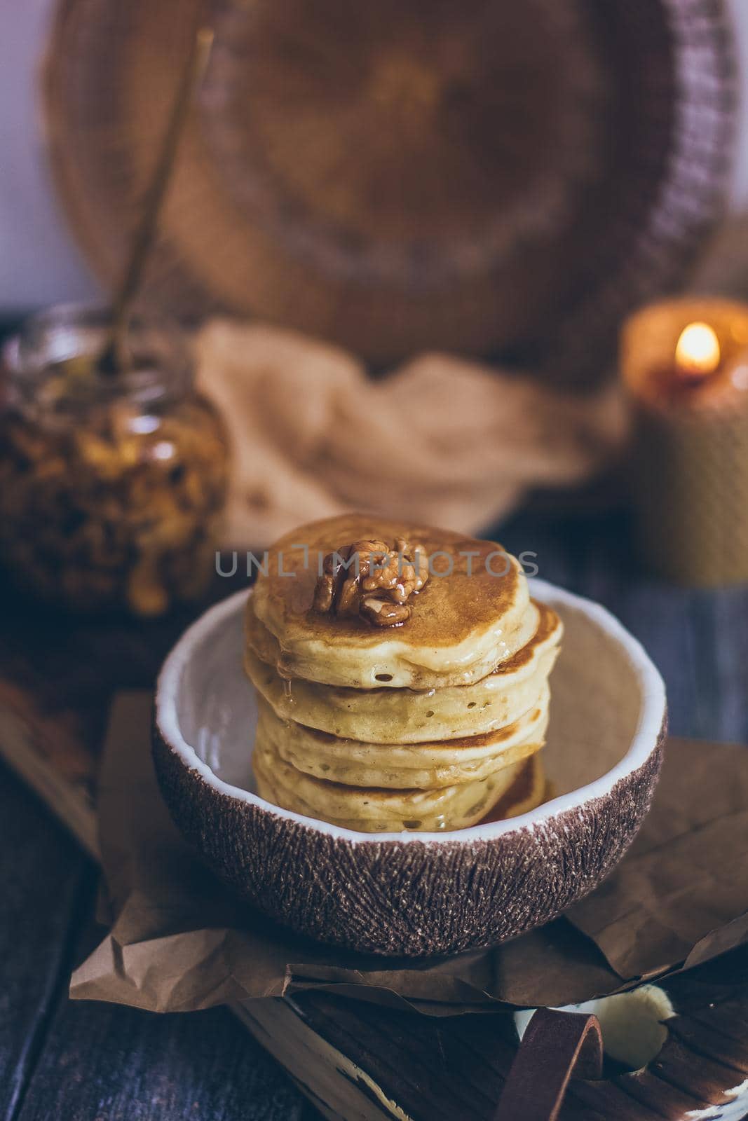 Stack of delicious pancakes with honey, nuts on wooden background by mmp1206