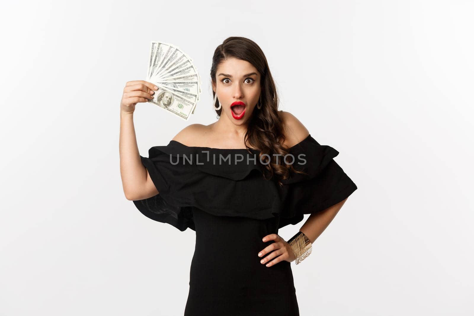Beauty and shopping concept. Fashionable woman with red lips, showing dollars and smiling, standing over white background with money by Benzoix