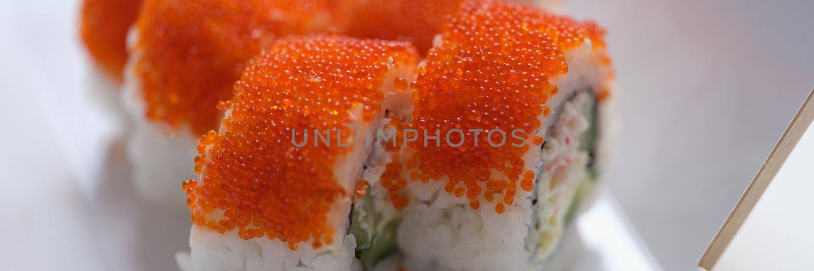 Roll California with cream cheese tobiko caviar. Fresh and tasty traditional Japanese sushi