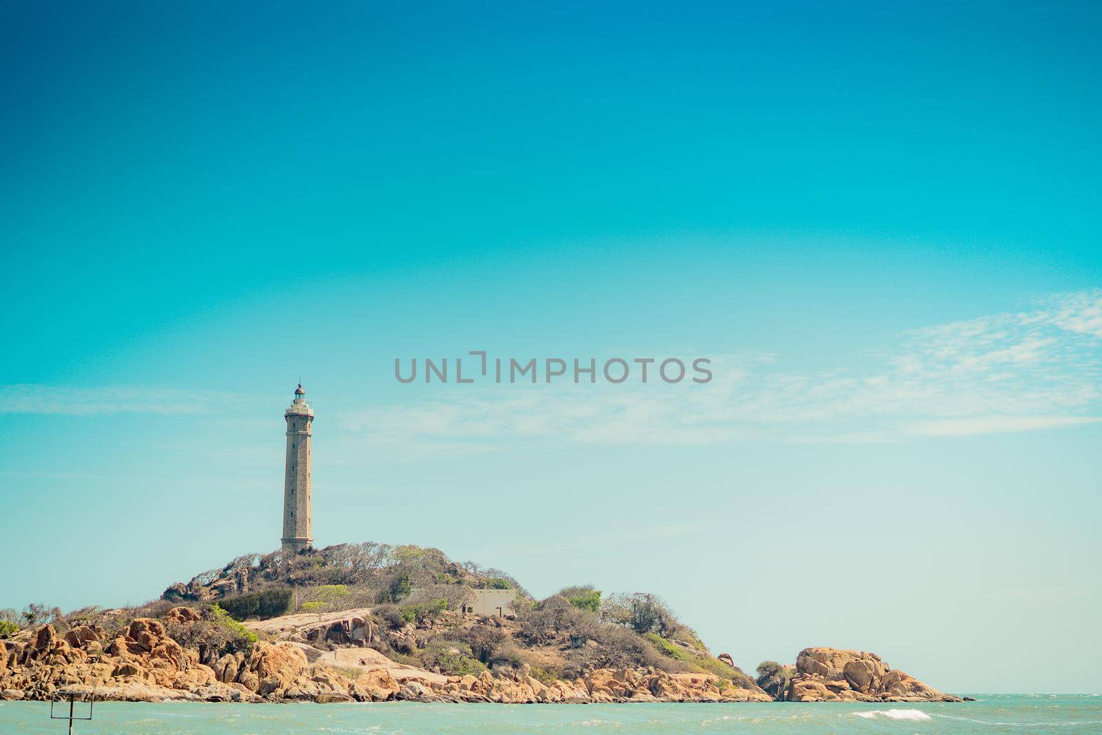 Sea nature panoramic view landscape background. Ocean rocky cliffs forested island. Clear blue sky. Lighthouse on mountain top. Signal warn sailors shipwreck, travel concept hope purpose of life.