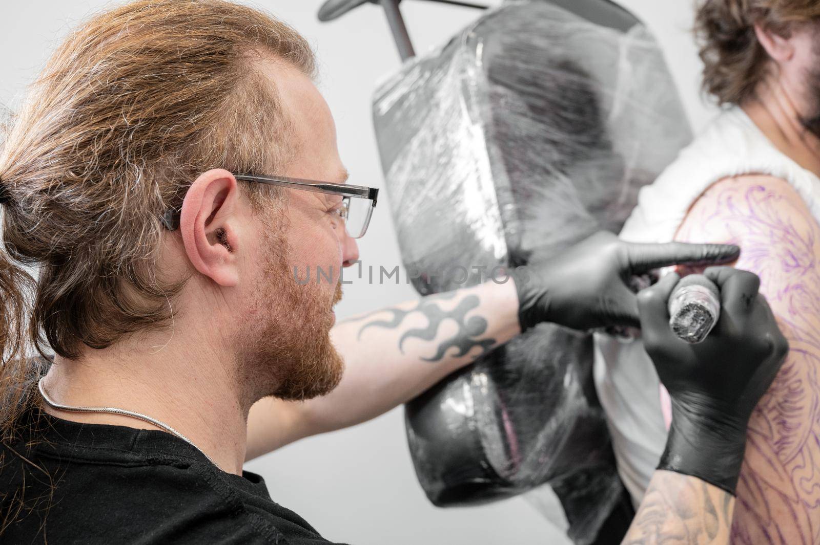 Salon tattoo. Close up of a Tattoo artist working. Tattoo artist make tattoo at the studio. High quality photography.