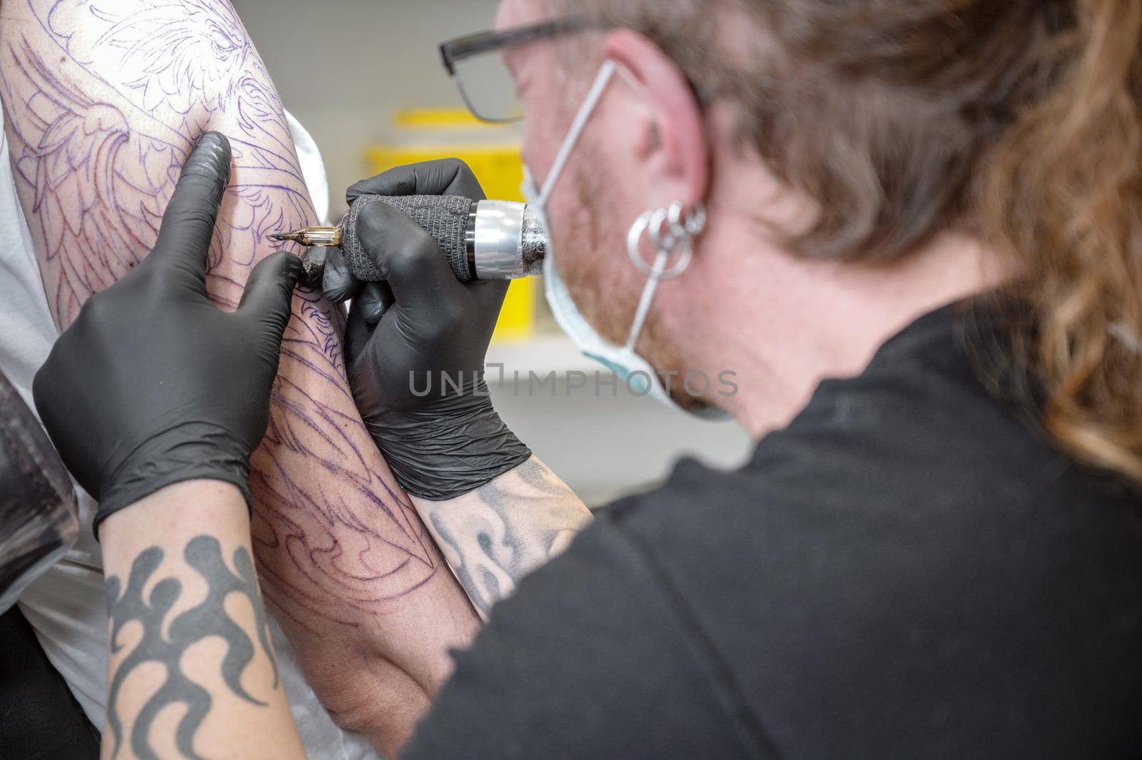 Salon tattoo. Close up of a Tattoo artist working. Tattoo artist make tattoo at the studio. High quality photography.