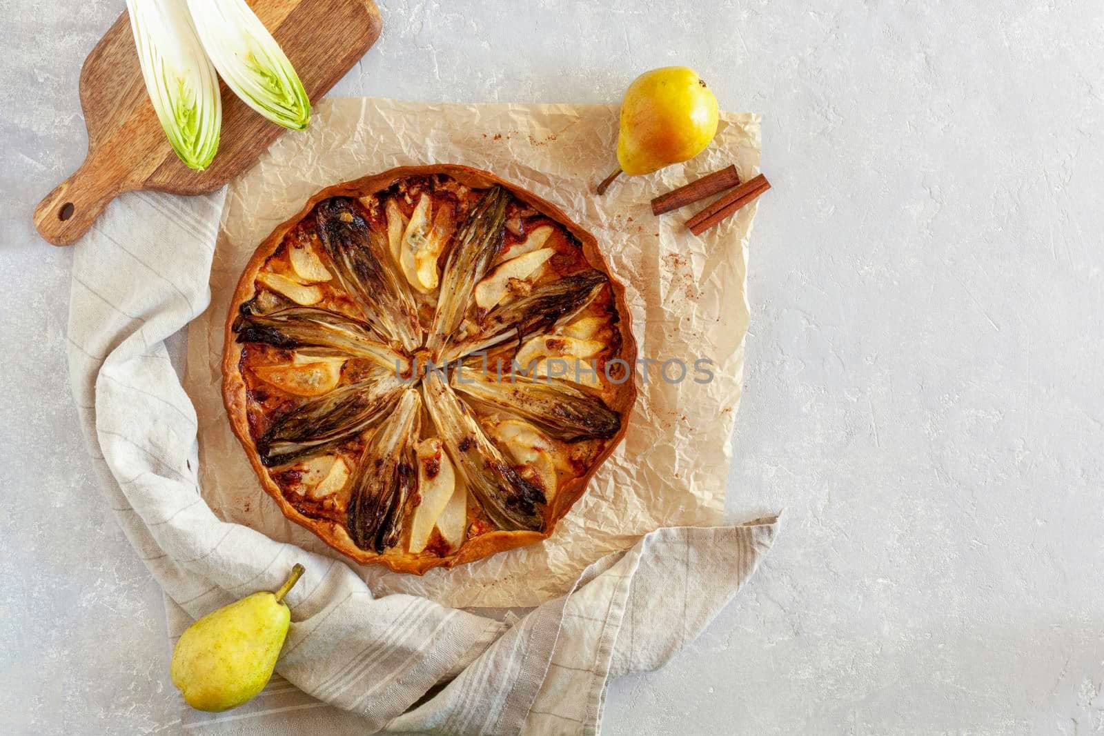 homemade endive, pear and gorgonzola tart, top view, copy space