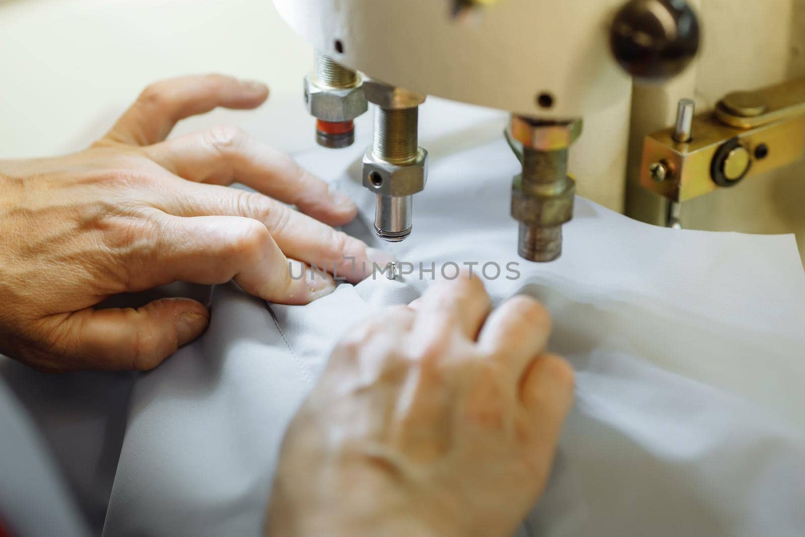 sewing machine scribbling fabric. tailoring at the factory.