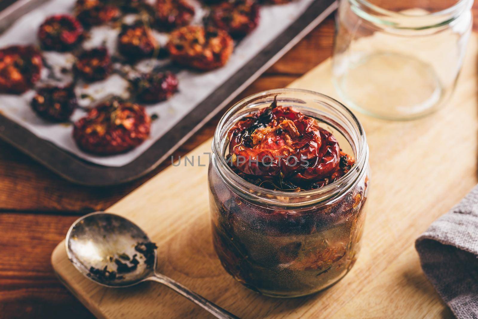 Freshly Prepared Sun Dried Tomatoes with Olive Oil and Herbs in a Glass Jar