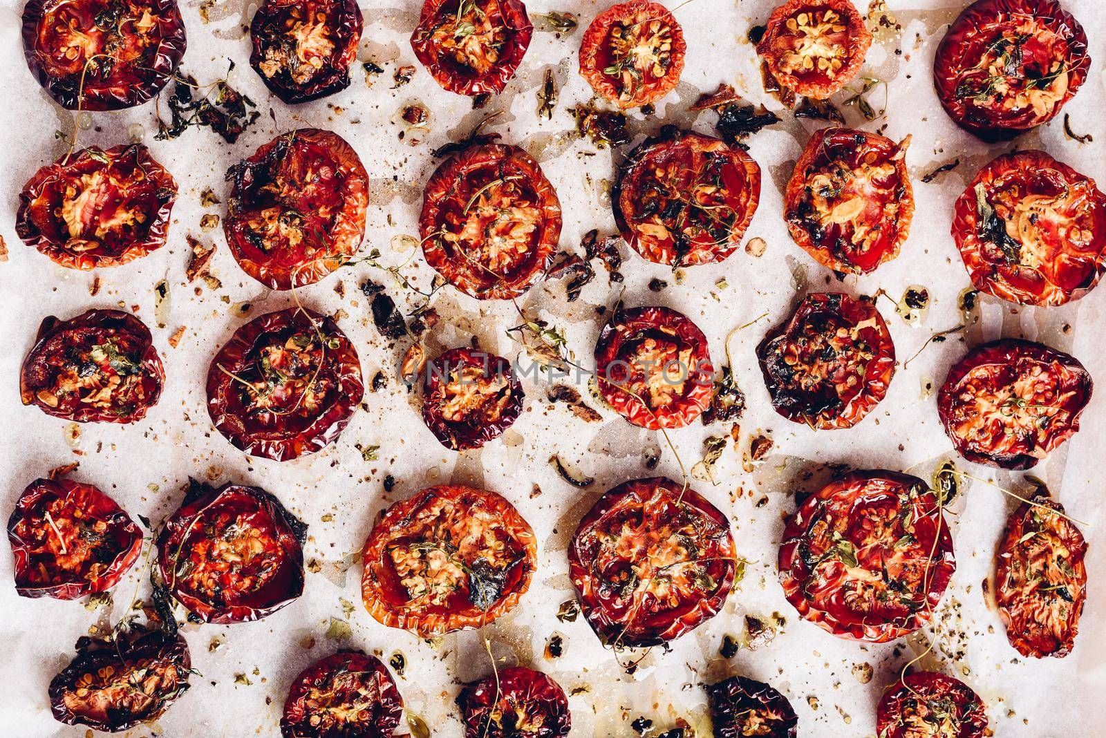 Prepared Sun Dried Tomatoes with Herbs on Parchment Paper by Seva_blsv