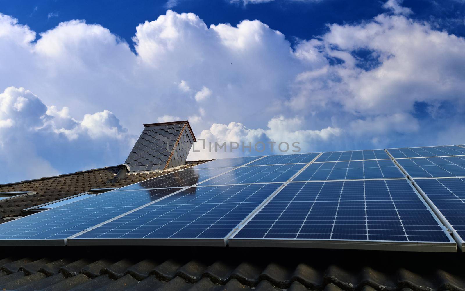 Solar panels producing clean energy on a roof of a residential house by MP_foto71