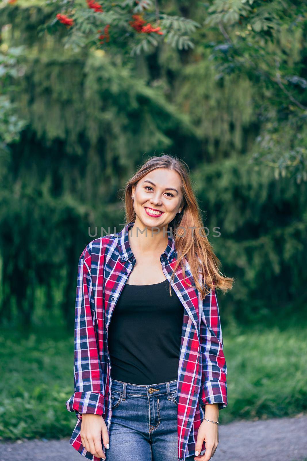 Smiling woman standing in the park by Seva_blsv