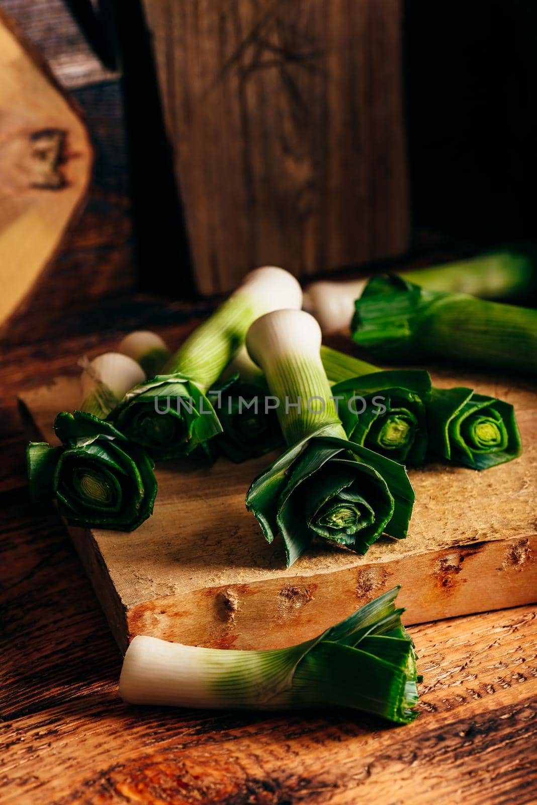 Fresh green leek on rustic cutting board