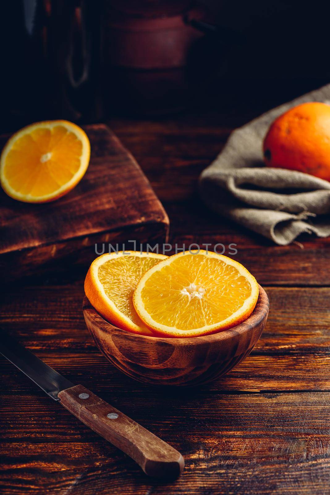 Slices of orange in a rustic bowl by Seva_blsv