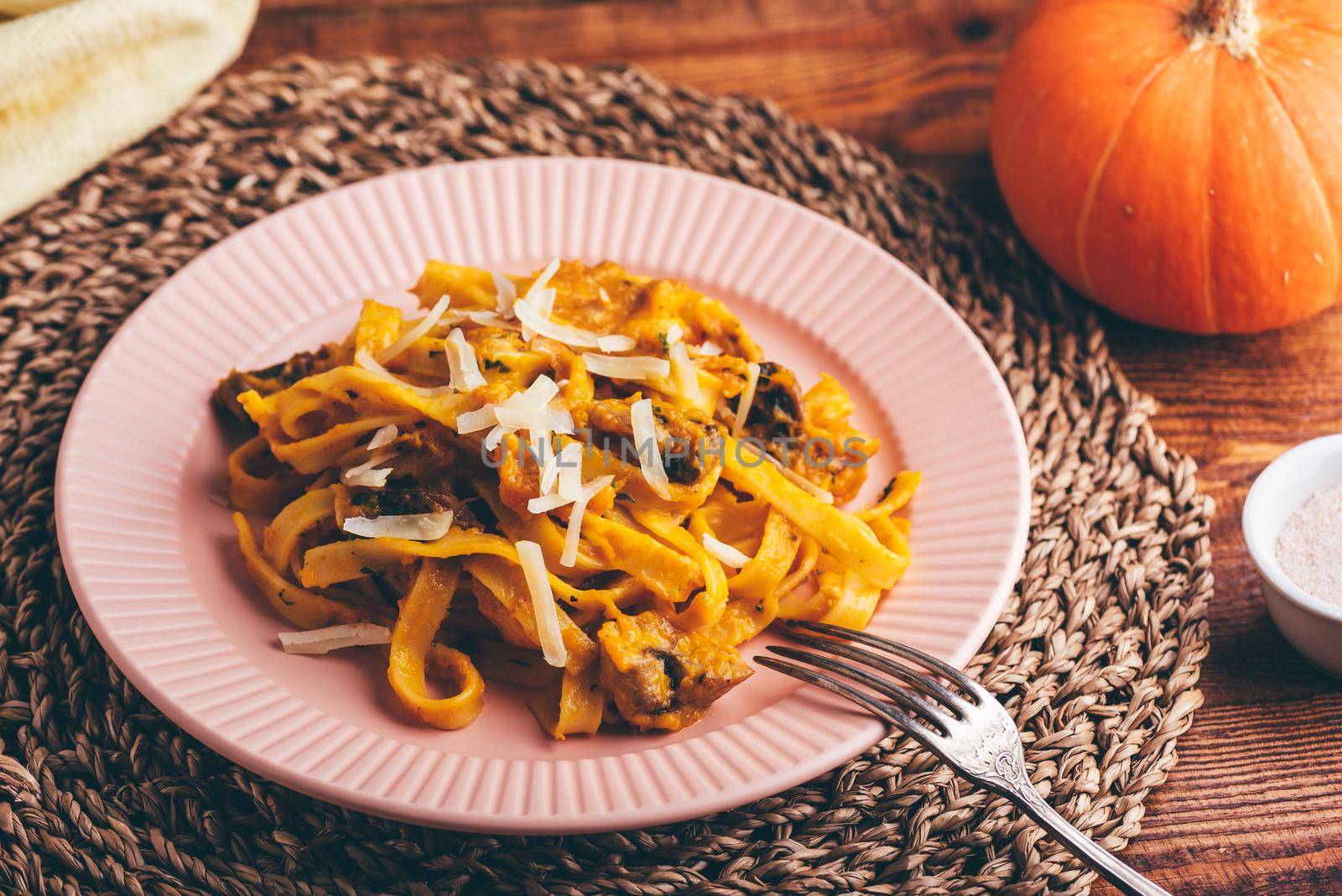 Fettuccine Pasta with Pumpkin Sauce and Mushrooms Garnished with Grated Parmesan Cheese
