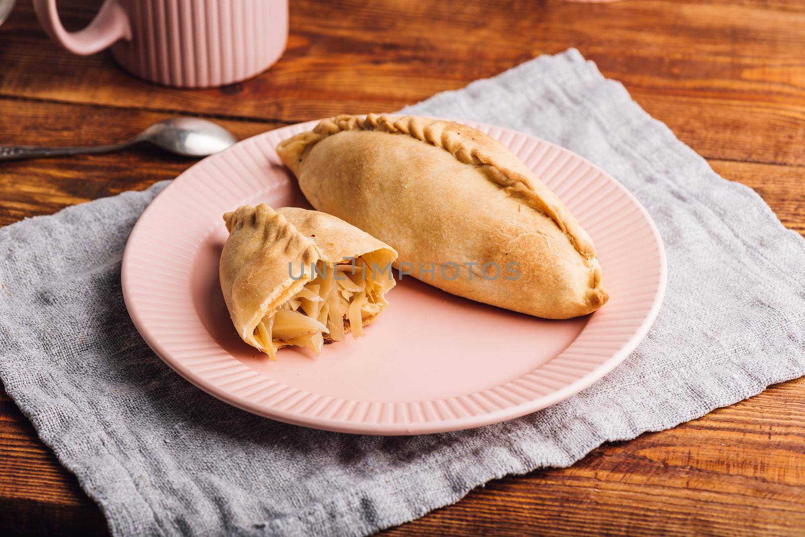 Oven Baked Cabbage Pies on Rustic Wooden Table