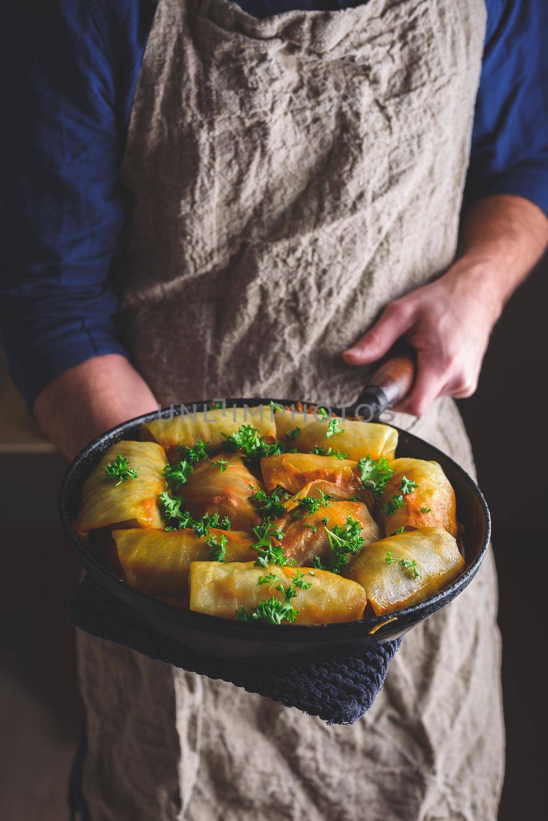 Chef Holding Pan with Cooked Cabbage Rolls by Seva_blsv