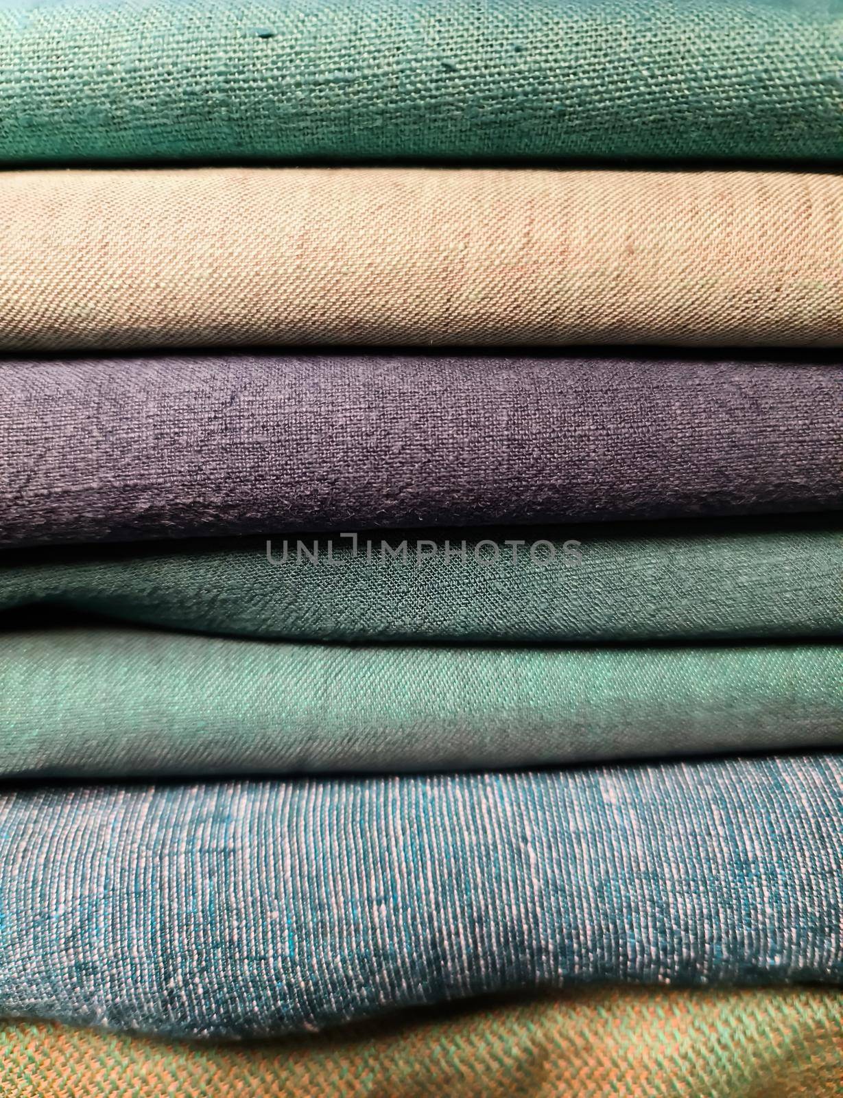 Detailed close up view on samples of cloth and fabrics in different colors found at a fabrics market.