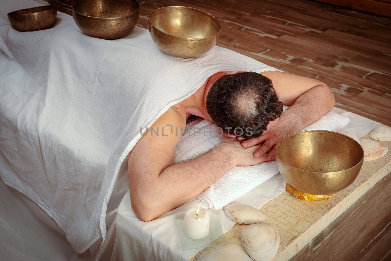 Men perform Tibetan rituals with sound bowls.