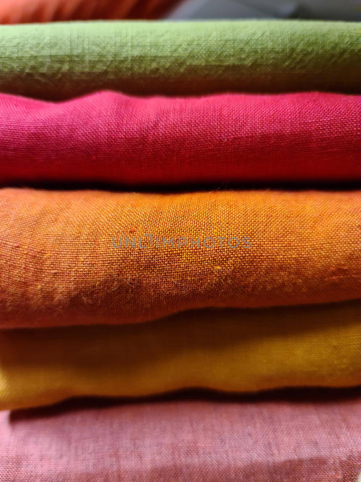 Detailed close up view on samples of cloth and fabrics in different colors found at a fabrics market.