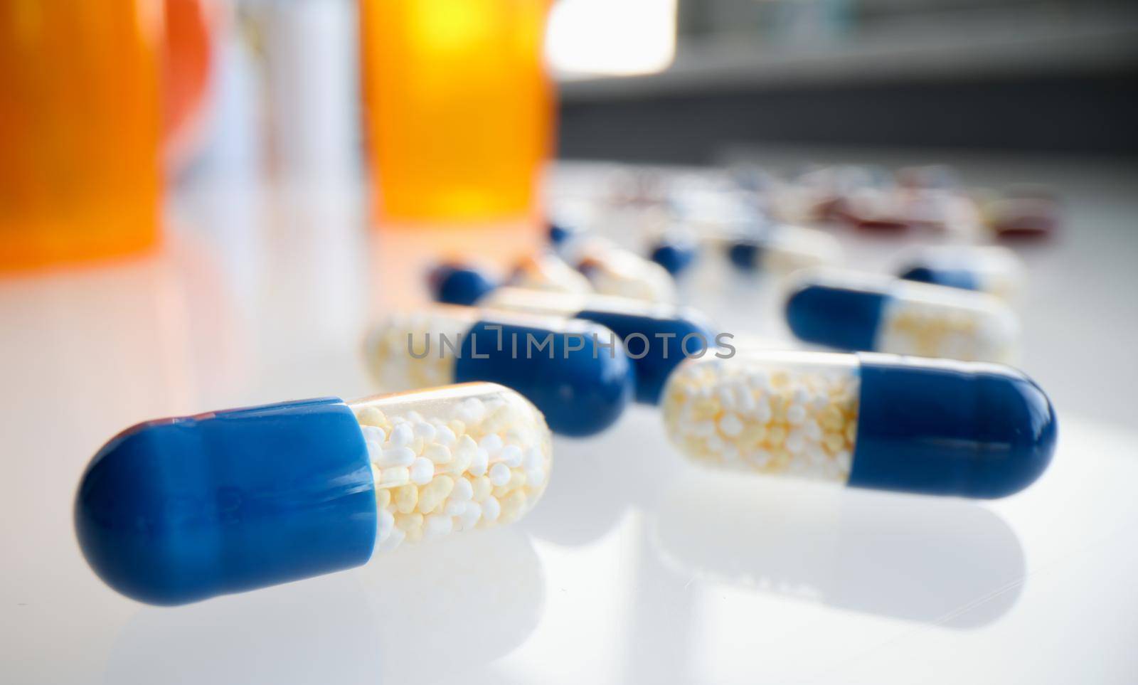 Medicine capsules and bottles of treat on white background closeup. Treatment with dietary supplements concept