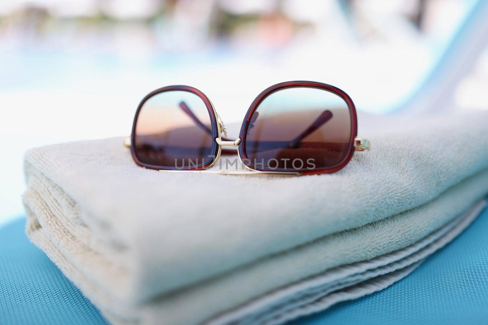 Stylish sunglasses on towel, accessory for good summertime rest by kuprevich