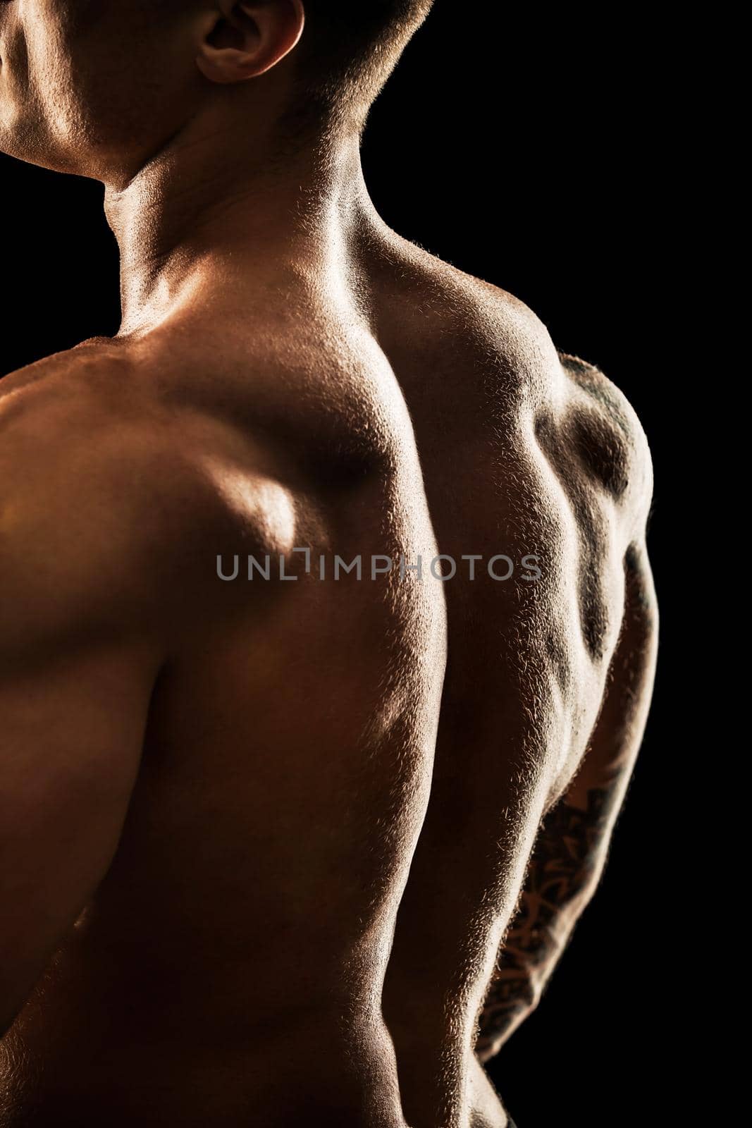 bodybuilder posing. Beautiful sporty guy male power. Fitness muscular body. Isolated on black background