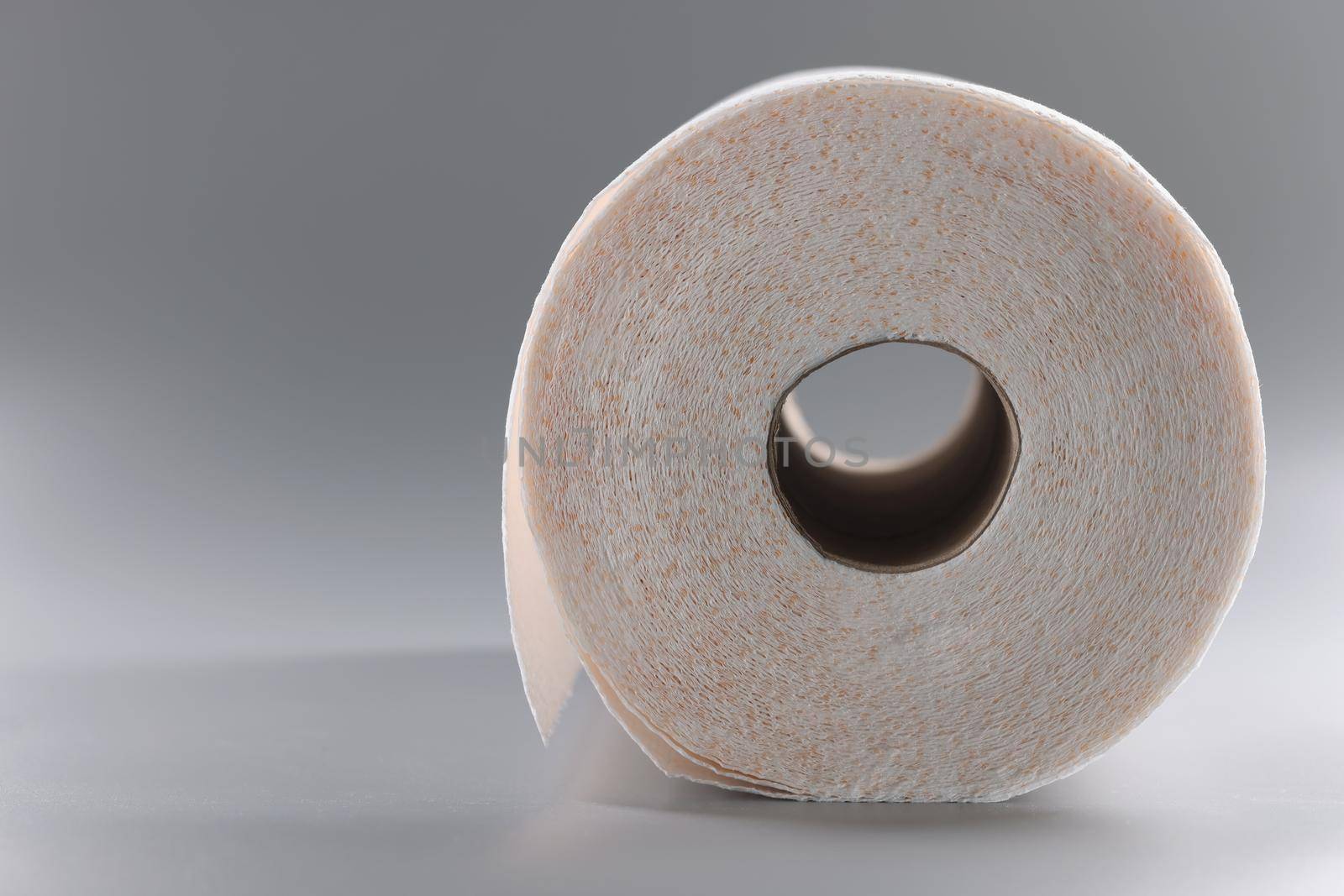 Close-up of white roll of paper for toilet, clean layers of tissue for personal hygiene. Unused paper for bathroom or toilet. Hygiene, cleaning concept
