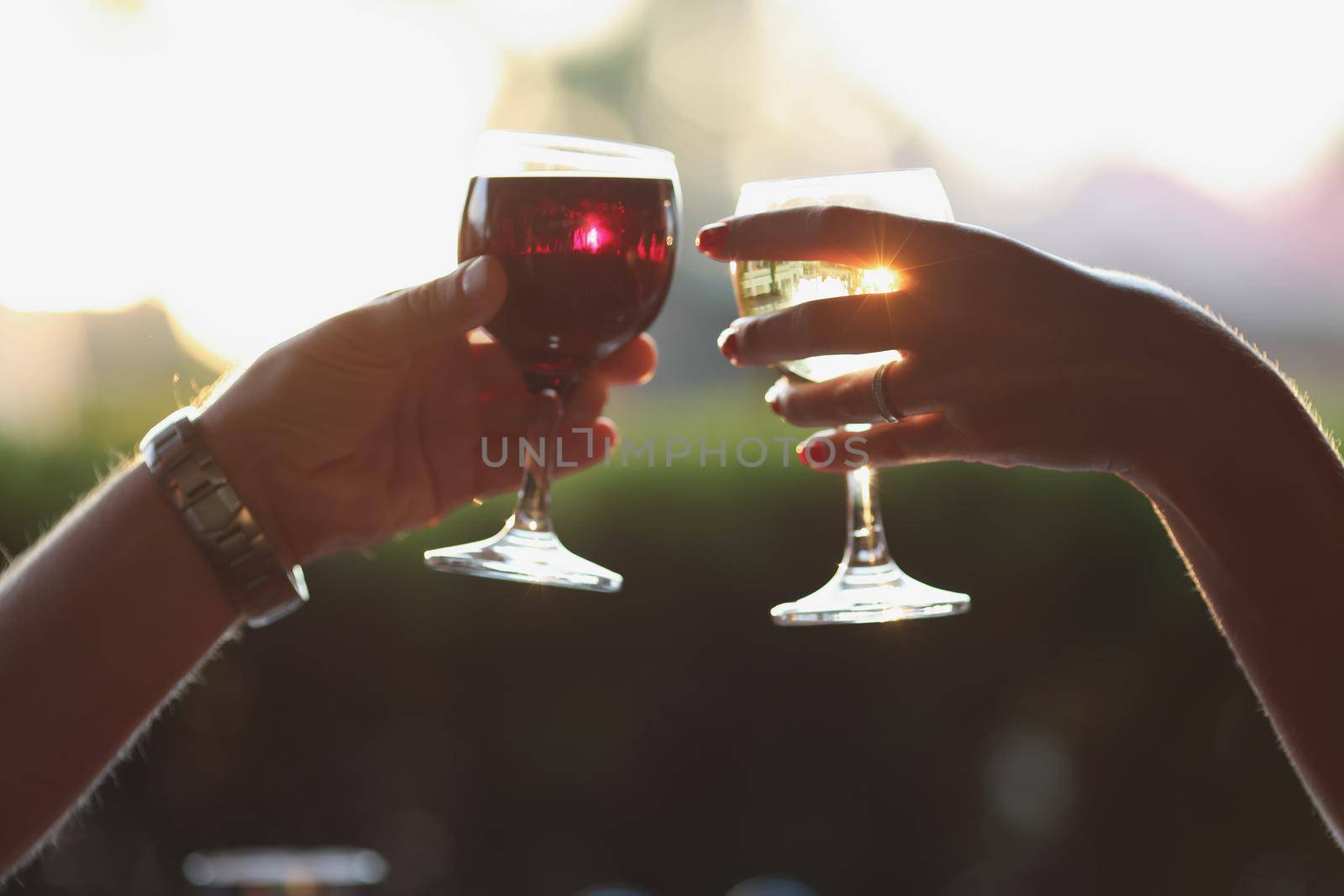 People clinking glasses filled with wine or champagne, alcoholic drink by kuprevich