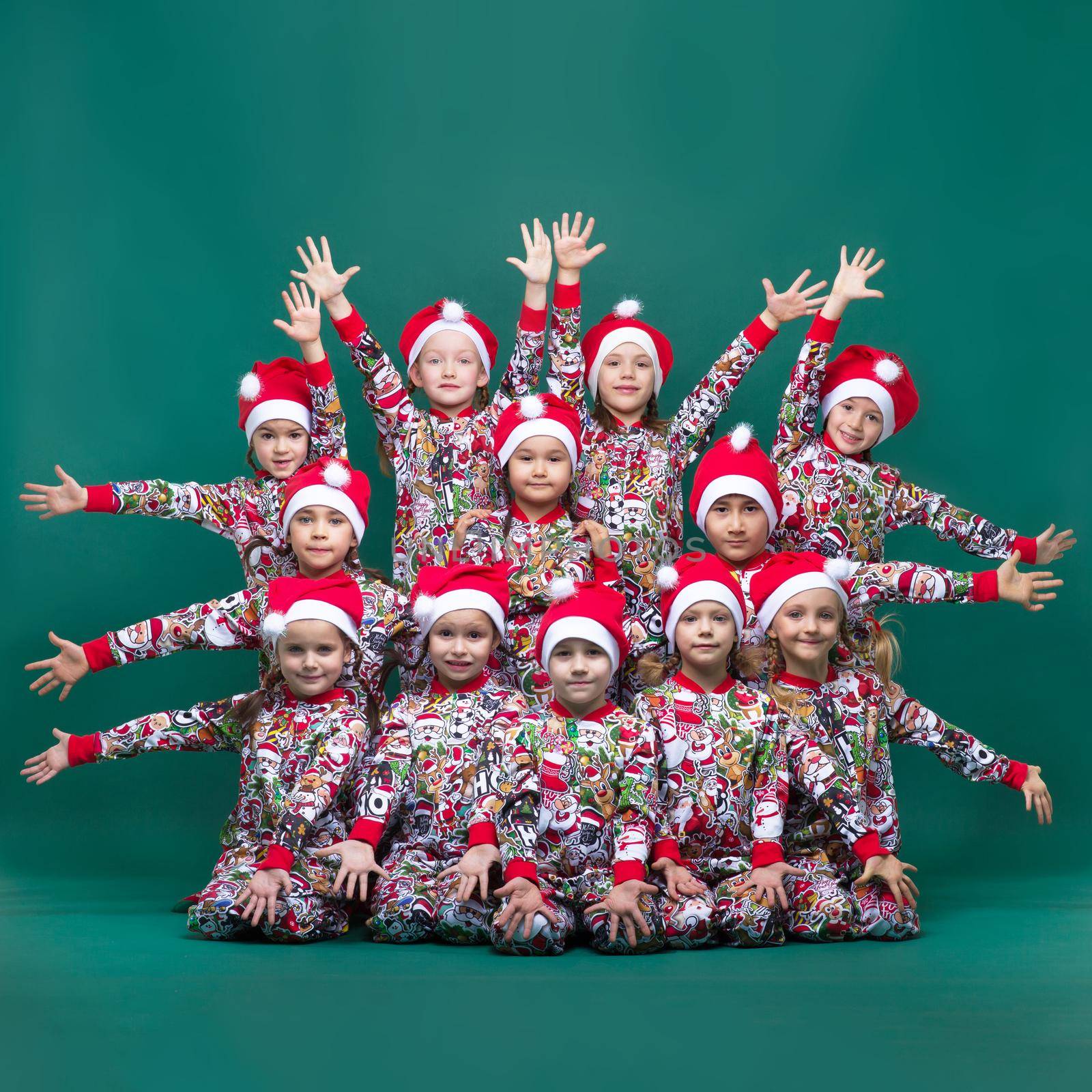 Group of kids posing with their hands outstretched by kolesnikov_studio
