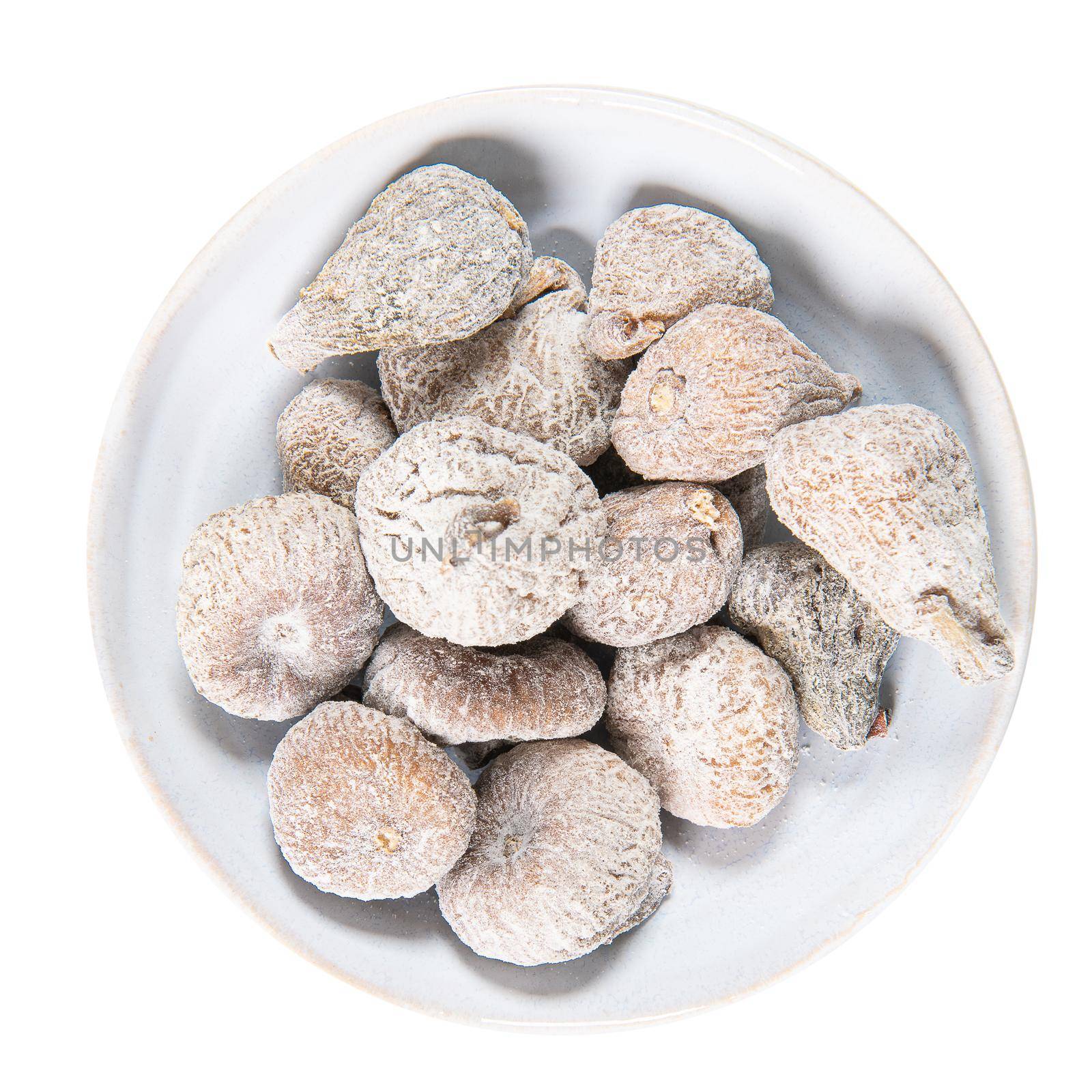 Dried figs in a white ceramic bowl. Dried fruit with copy space for text. Top view. Figs isolated on white background.