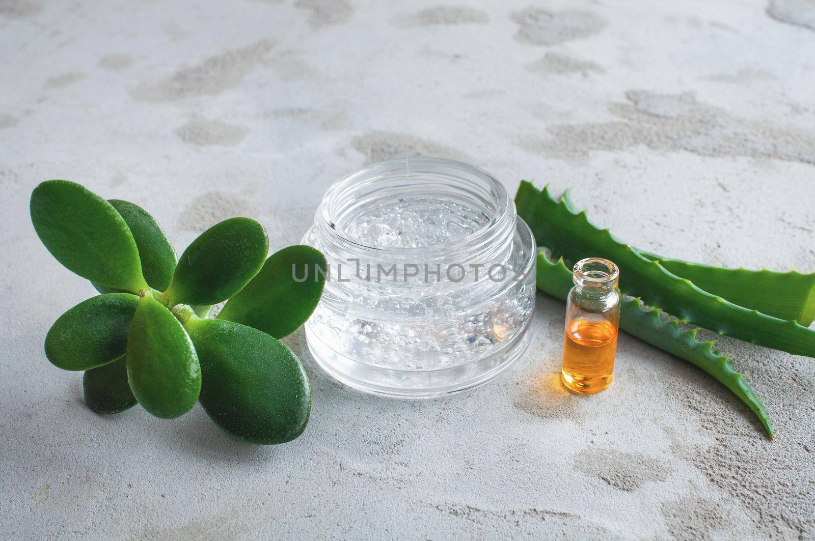 Transparent jar with cosmetic moisturizing gel with hyaluronic acid with bubbles and vitamins in capsules