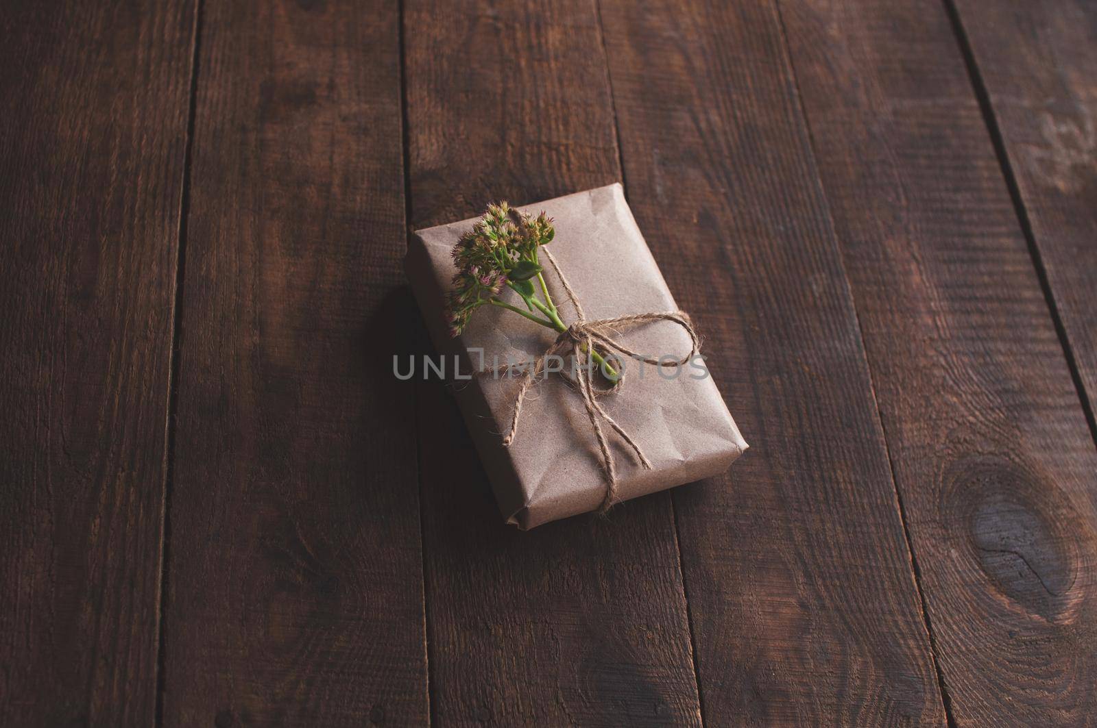 gift wrapped in wrapping kraft paper, decorated with flowers