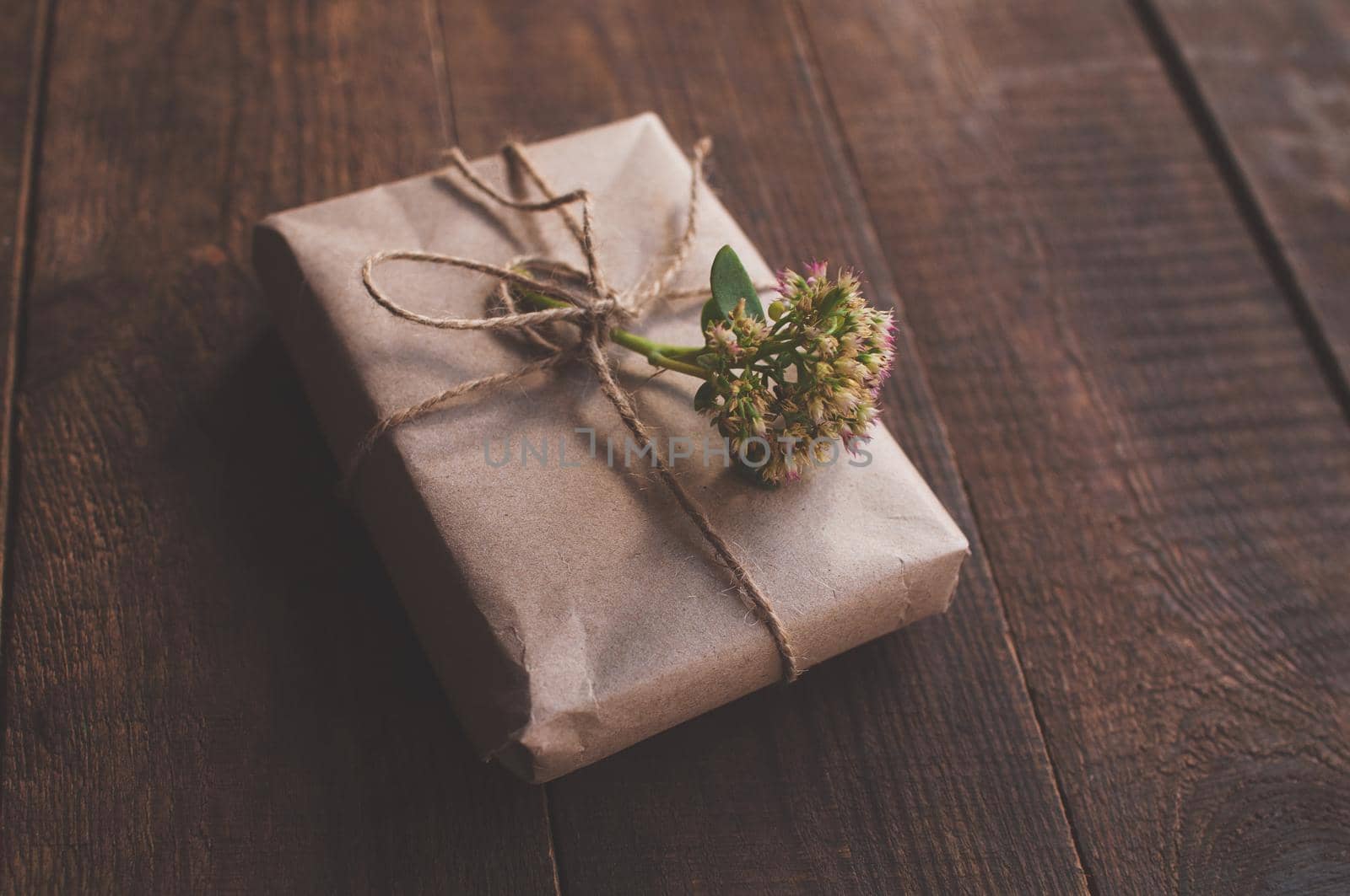 gift wrapped in wrapping kraft paper, decorated with flowers