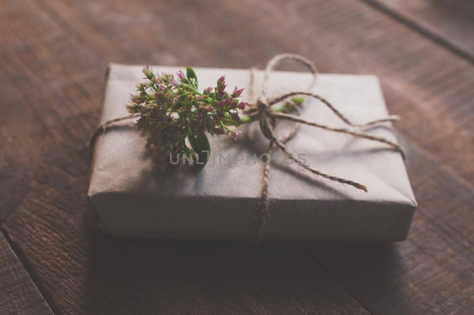 gift wrapped in wrapping kraft paper with a flower on top