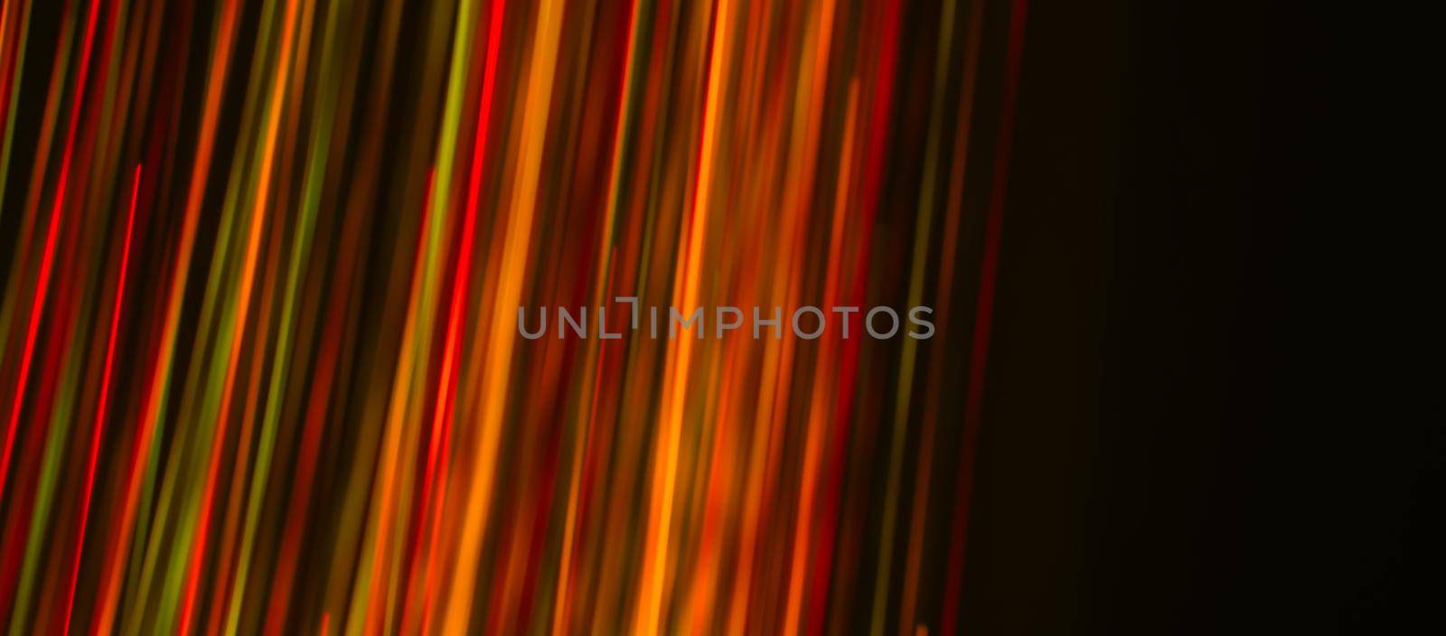 Multi-colored rays on a dark background. Abstraction. Drawing with light. Photoelectric effect. by orebrik